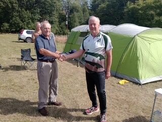 Club Secretary Colin West presents John with his prizes